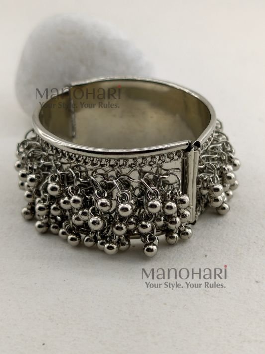 **Aarvi Silver Ghungroo Bracelet crafted from premium alloy metal with an elegant silver-tone finish, featuring delicate ghungroo detailing, an openable fold-over clasp, and a comfortable 6 cm inner diameter, perfect for festive and ethnic styling.**