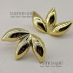 **Aarna Petal Drop Earrings are a perfect blend of modern sophistication and floral-inspired elegance. Expertly crafted from **premium brass** with a radiant **gold-tone finish**, these statement earrings feature graceful **petal-shaped drops** with a smooth, polished surface that beautifully reflects light. Their lightweight design ensures exceptional comfort, making them ideal for all-day wear without compromising on style. Whether paired with **Kerala Kasavu sarees, silk sarees, kurtis, dresses, co-ord sets, or Indo-western outfits**, these elegant earrings effortlessly enhance both casual and festive looks. Perfect for **Onam, weddings, brunches, office wear, parties, receptions, date nights, and everyday styling**, the **Aarna Petal Drop Earrings** are exclusively curated by **Manohari Style** to bring timeless floral charm, premium craftsmanship, and understated luxury to every jewellery collection.**