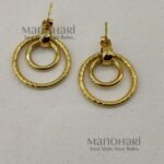 Haya Spiral Hoop Earrings with two twisted gold spiral hoops and one plain loop in an anti-tarnish finish