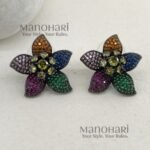 Elara Rainbow Bloom multicolor AD stud earrings with artificial colorful stones, black rhodium polished brass base and 3 cm floral design for women