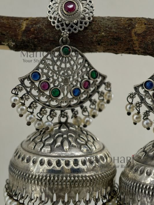 MN-ER-THJ-ISH-01_3 Ishira Tribal Heritage Jhumkas with silver-look finish, stone-studded design and pearl hangings, 8 cm traditional statement earrings for women