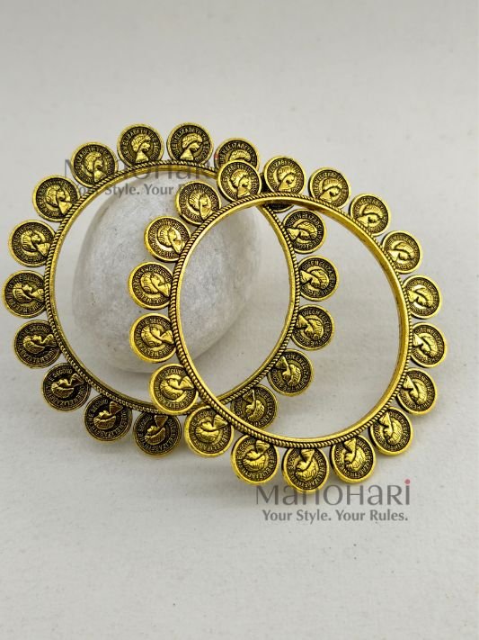 **Svara Dual Tone Heritage Kada Pair crafted in an elegant oxidised metal and golden-tone finish, featuring a heritage-inspired Banjara and Boho Chic design with a comfortable 5.5 cm inner diameter and a secure non-openable fit for timeless ethnic styling.**