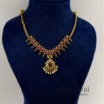 **Aarna Bloom Petal Necklace crafted from premium brass, adorned with sparkling artificial stones in an elegant floral petal design, featuring a 15 cm necklace with an adjustable extension thread and matching 3 cm earrings for timeless feminine elegance.**