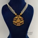 **Vaidehi Ruby Heritage Haram crafted from premium copper brass, adorned with vibrant Ruby Green Kemp stones and elegant pearl drops, featuring a 29 cm traditional Muthyala Haram with matching 4 cm push-back earrings for weddings, festive occasions, and timeless South Indian styling.**