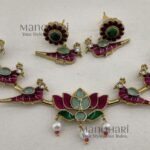 Kavya Jadau Meenakari Lotus Hasli Choker Set features an elegant lotus-inspired design with traditional Jadau and Meenakari detailing, crafted in brass with a Kundan extension chain and convenient push-button clasp. Perfect for weddings, Onam, festivals and special occasions, this statement choker beautifully complements sarees, lehengas and ethnic outfits.