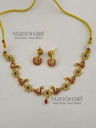 **Morika Peacock Heritage Necklace crafted from a premium alloy metal base with a luxurious gold-plated antique finish, adorned with vibrant Kemp-inspired stones, AD/CZ accents, Kundan-style detailing, pearls, and decorative beads, featuring an elegant peacock motif with matching earrings for timeless bridal and festive elegance.**
