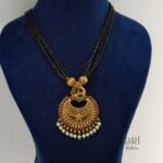 Morika Peacock Royale Necklace Set featuring a traditional peacock-inspired brass design, elegant black bead chain, 27 cm necklace, and matching 3 cm earrings for festive and ethnic wear.