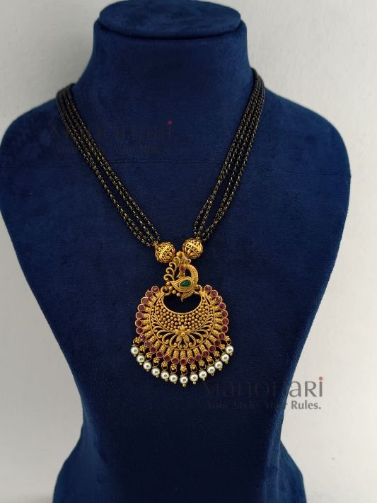 Morika Peacock Royale Necklace Set featuring a traditional peacock-inspired brass design, elegant black bead chain, 27 cm necklace, and matching 3 cm earrings for festive and ethnic wear.