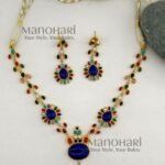 **Aadhira Heritage Polki Necklace Set featuring an antique gold-plated finish, a stunning Labradorite-inspired centre stone, vibrant multicoloured Polki-style embellishments, an elegant 18.5 cm floral necklace, and matching 6 cm statement earrings for timeless bridal and festive elegance.**