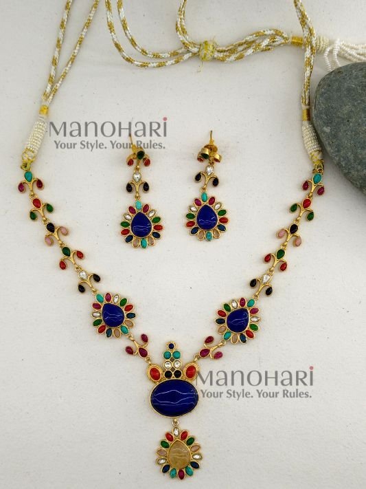 **Aadhira Heritage Polki Necklace Set featuring an antique gold-plated finish, a stunning Labradorite-inspired centre stone, vibrant multicoloured Polki-style embellishments, an elegant 18.5 cm floral necklace, and matching 6 cm statement earrings for timeless bridal and festive elegance.**