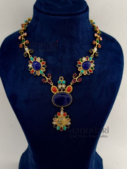**Aadhira Heritage Polki Necklace Set featuring an antique gold-plated finish, a stunning Labradorite-inspired centre stone, vibrant multicoloured Polki-style embellishments, an elegant 18.5 cm floral necklace, and matching 6 cm statement earrings for timeless bridal and festive elegance.**