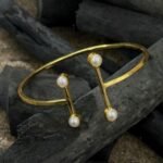 Aarna Pearl Elegance Cuff Bracelet crafted from brass material, featuring an elegant pearl-inspired design and approximately 6 cm inner diameter.