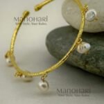 Kiara Gold Pearl Elegance Bangle crafted from brass, featuring an adjustable pearl hanging design and approximately 6 cm inner diameter.