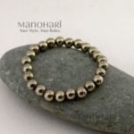 Aadhya Pyrite Luxe Crystal Bracelet featuring hand-picked natural pyrite stones with a striking metallic golden shine in a stretch bracelet design.