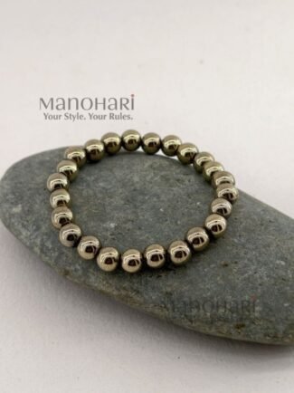 Aadhya Pyrite Luxe Crystal Bracelet featuring hand-picked natural pyrite stones with a striking metallic golden shine in a stretch bracelet design.
