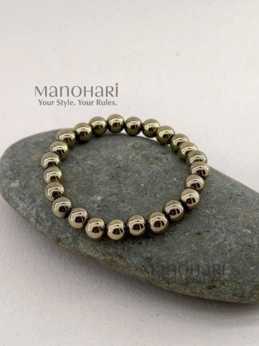 MN-BR-PYT-APL-01_1 Aadhya Pyrite Luxe Crystal Bracelet featuring hand-picked natural pyrite stones with a striking metallic golden shine in a stretch bracelet design.
