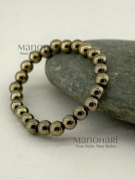 MN-BR-PYT-APL-01_2 Aadhya Pyrite Luxe Crystal Bracelet featuring hand-picked natural pyrite stones with a striking metallic golden shine in a stretch bracelet design.