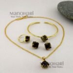 Vanya Natural Stone Gold Royale 4-Piece Jewellery Set featuring a brass gold-plated chain with pendant, ear studs, adjustable bracelet and finger ring with natural stone detailing