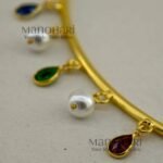 Anvika Multicolor Grace Hasli necklace set with multicolor glass stones, gold polish brass neckpiece, matching earrings and adjustable bangle